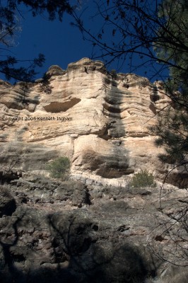 cliff face with shelter cave and rock varnish
