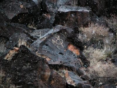 Two circular petroglyphs in a snowstorm
