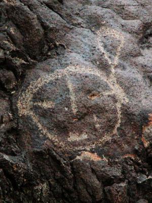 A petroglyph where the artist used a natural hole for an eye
